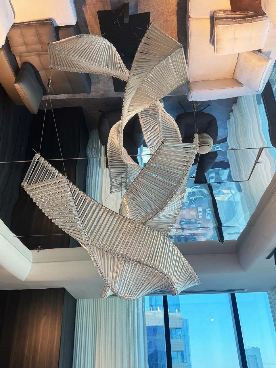 Sculptural glass lighting beneath a mirrored ceiling in the Nakheel Tower VIP lounge, Riyadh